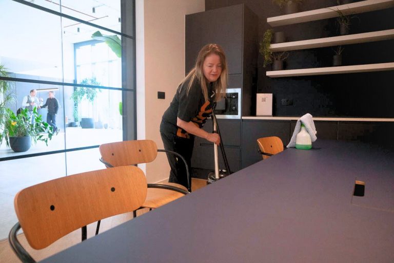 Form Communal employee vacuuming office