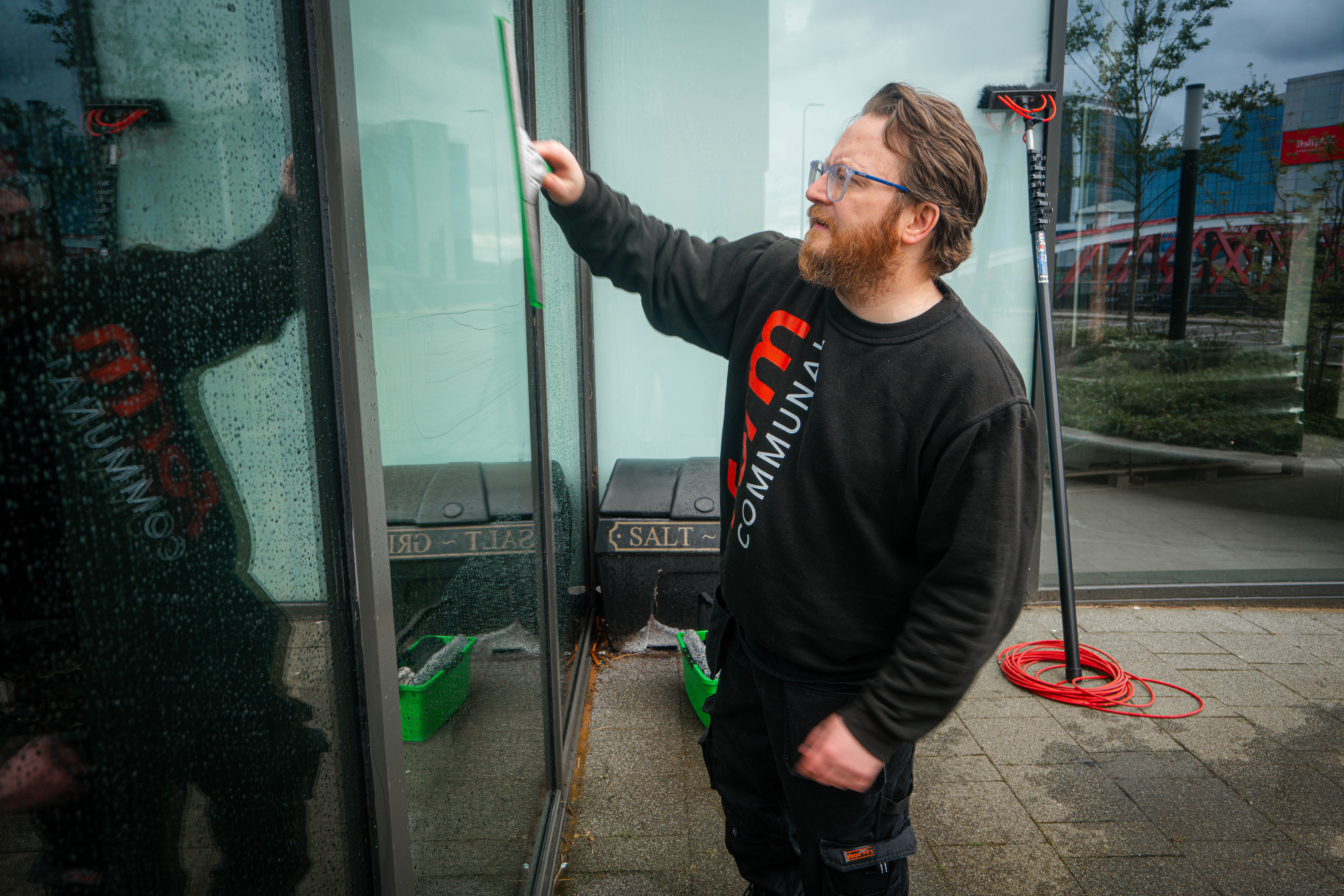 Man professionally cleaning windows
